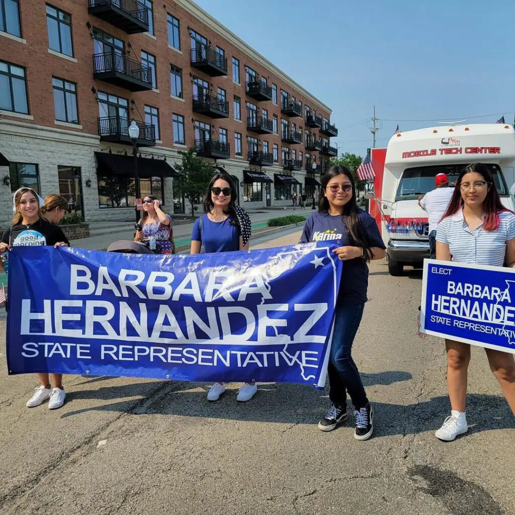  a group of women holding a tarpaulin that says Barbara Hernandez state representative