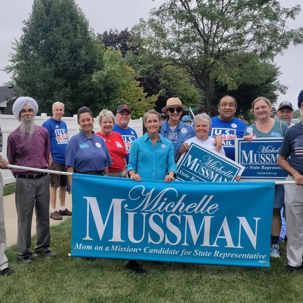 a group of people supporting michelle mussman for state representative