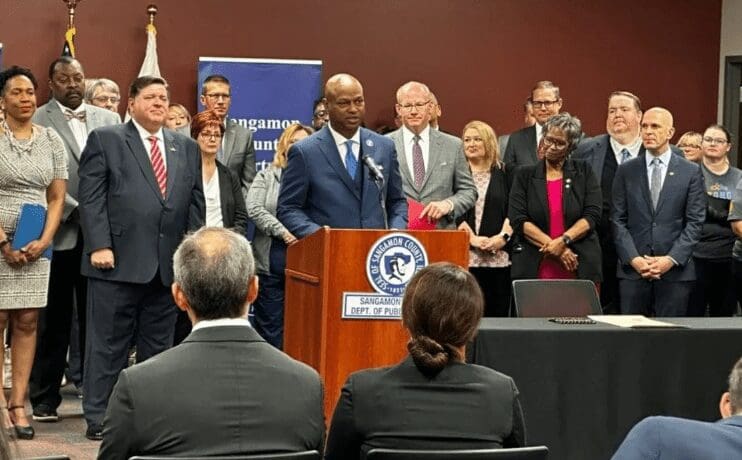 House Speaker Emanuel “Chris” Welch (center) joins state leaders and healthcare workers at the Sangamon County Department of Public Health Thursday to recognize the end of the state and federal COVID emergency orders.