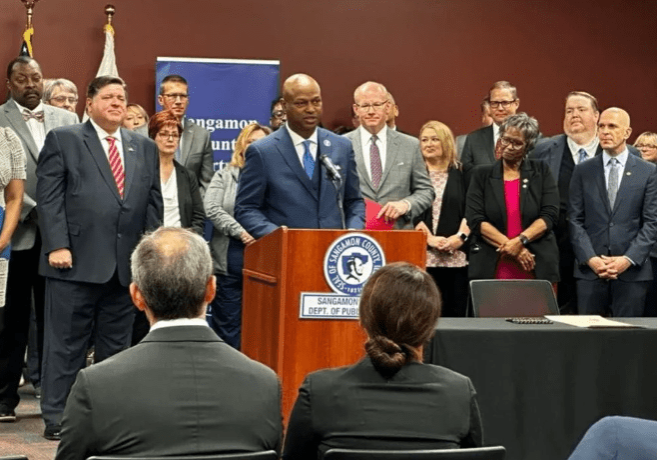 House Speaker Emanuel “Chris” Welch (center) joins state leaders and healthcare workers at the Sangamon County Department of Public Health Thursday to recognize the end of the state and federal COVID emergency orders.